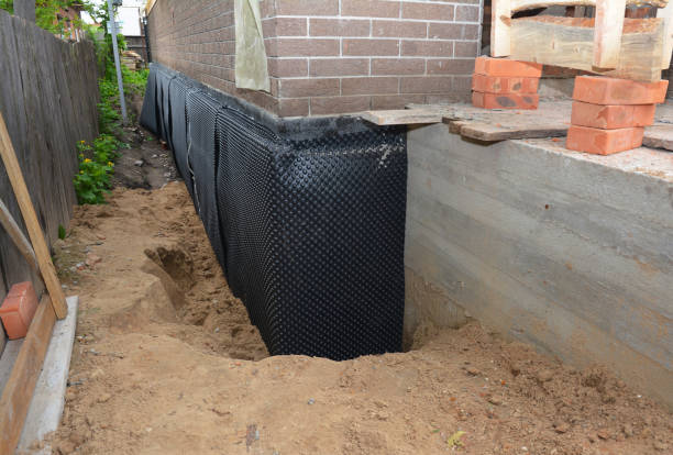 Happy homeowners after waterproofing job in Kodak